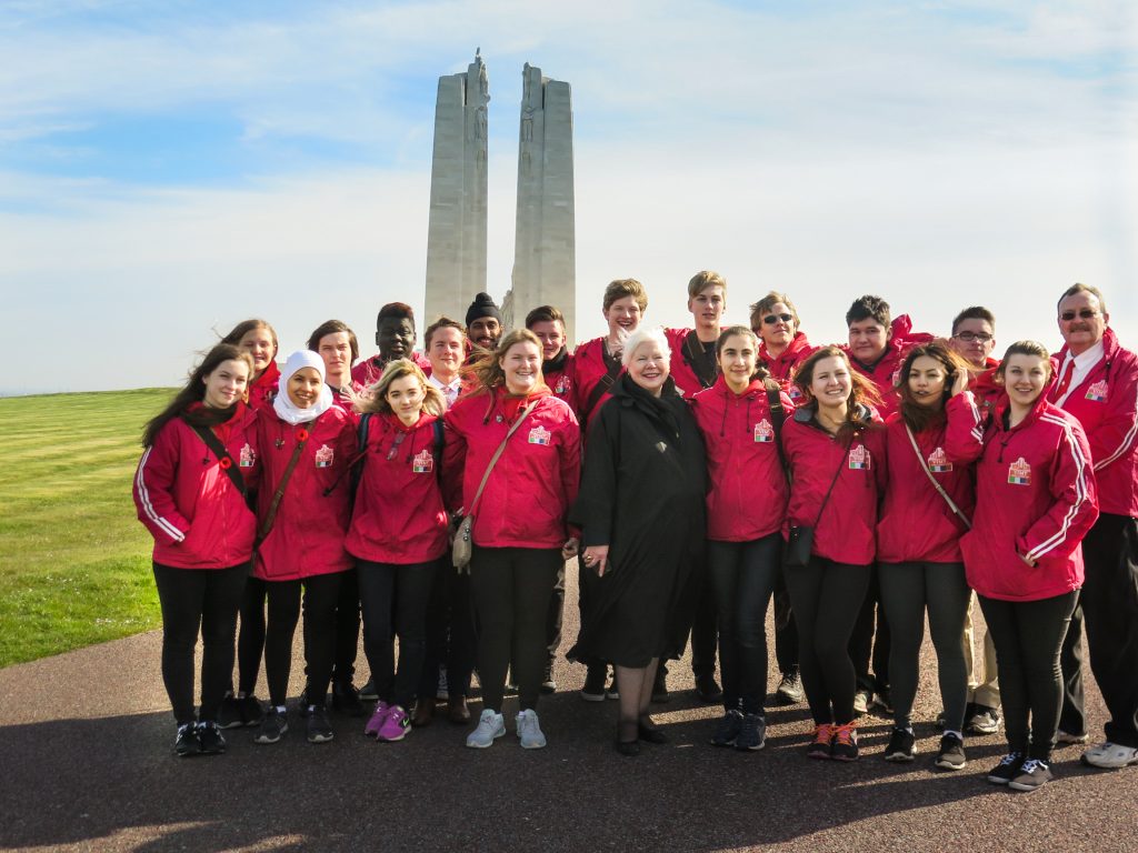 The Lieutenant Governor stands with students in front of the Vimy Ridge Memorial 
