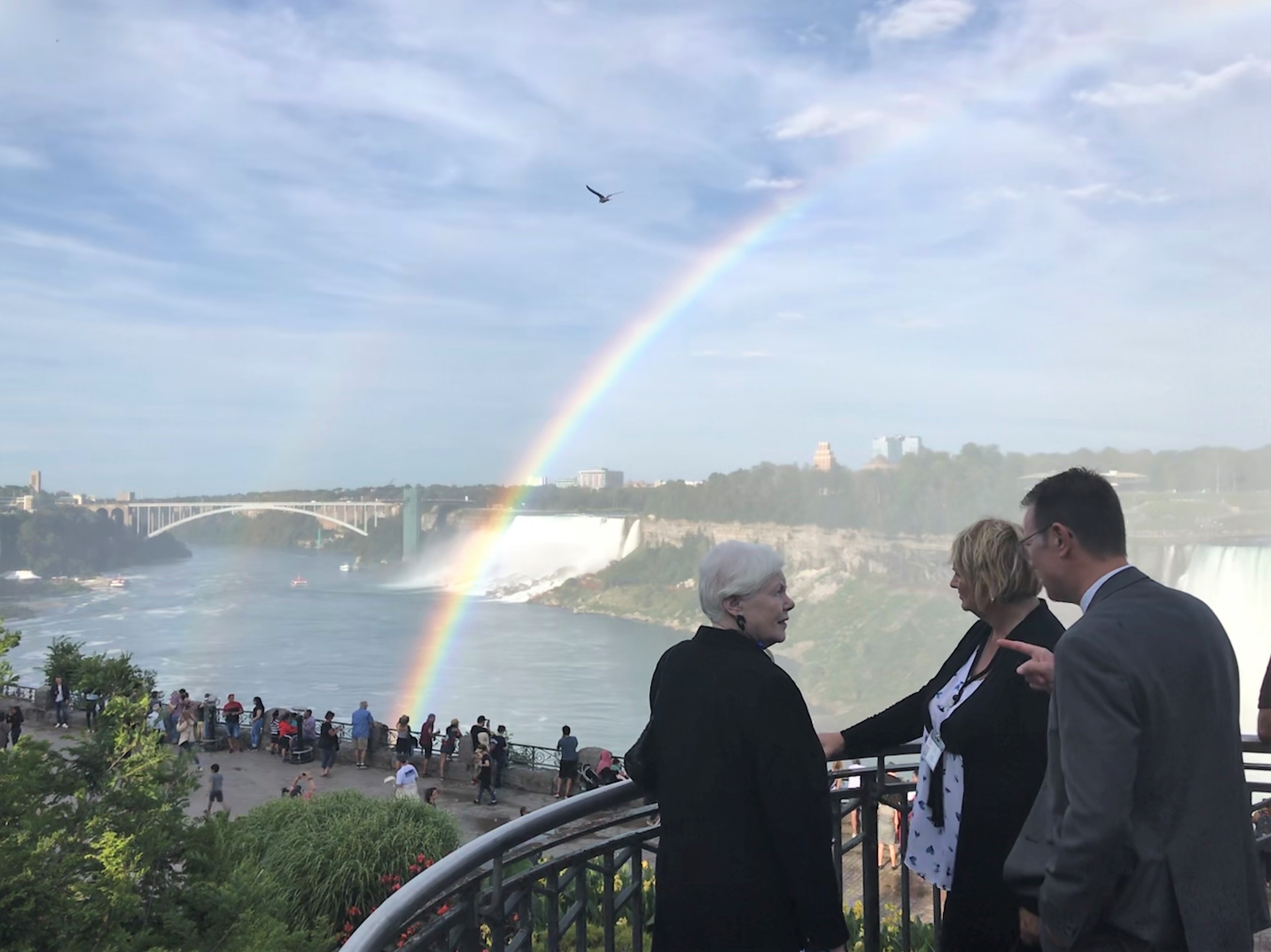 The Lieutenant Governor stands in front of Niagara Falls with Niagara Parks Commission, CEO, David Adames, and Chair  Sandy Bellows